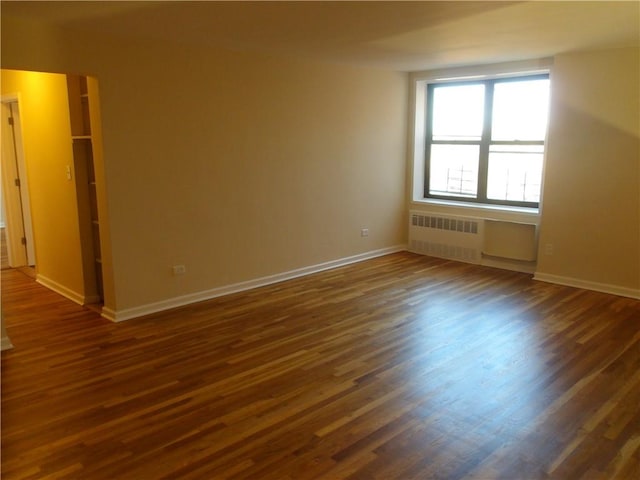 1200 E 53rd St Unit 7B, Brooklyn, NY 11234 - unfurnished room with radiator, dark wood-type flooring, and baseboards
