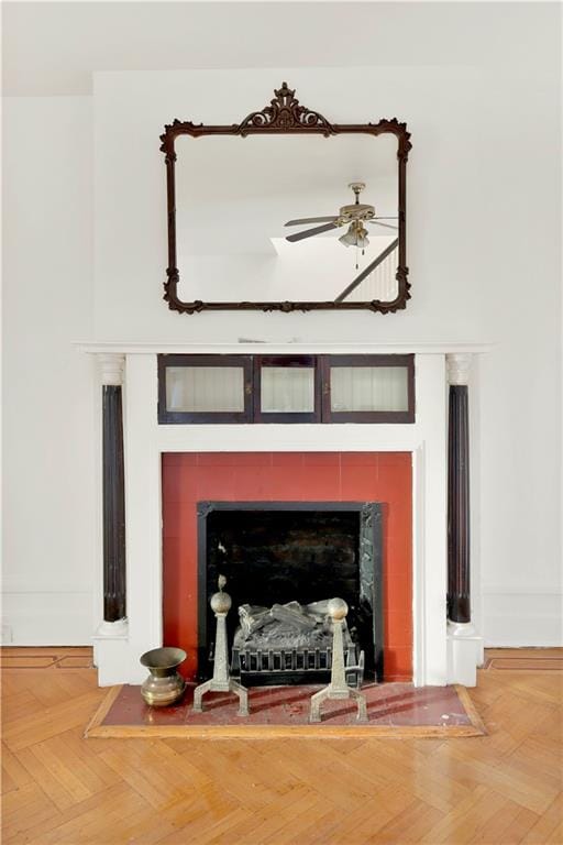 details with ceiling fan and a fireplace