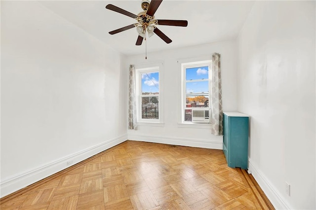 spare room featuring ceiling fan and light parquet flooring