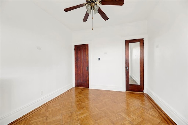 spare room featuring ceiling fan and light parquet flooring