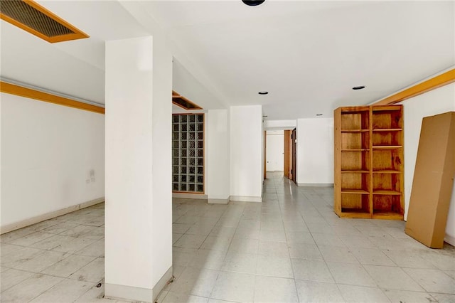 spare room with baseboards and visible vents