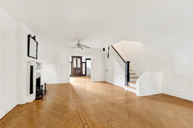 unfurnished living room featuring ceiling fan and light parquet floors