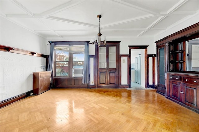 unfurnished living room featuring beam ceiling, light parquet flooring, and wood walls