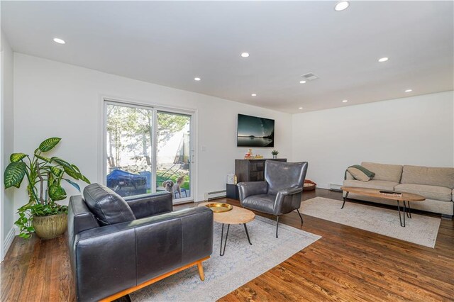 living room with a baseboard radiator and dark hardwood / wood-style flooring