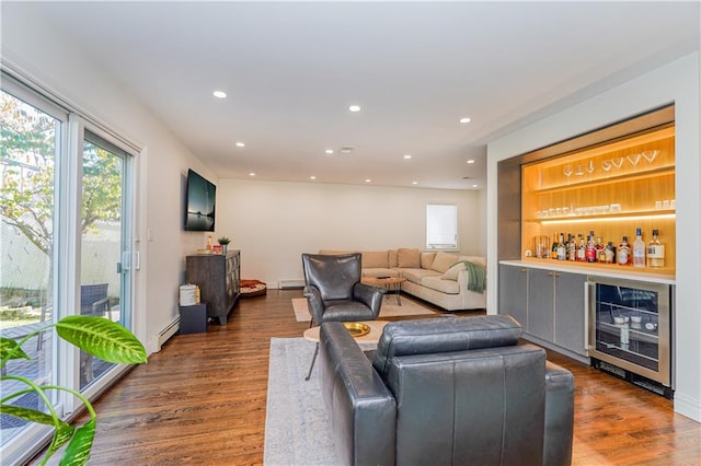 living room featuring dark wood-type flooring, bar, beverage cooler, and a baseboard radiator