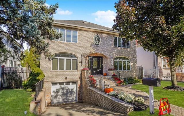 view of front of home with a garage and a front yard