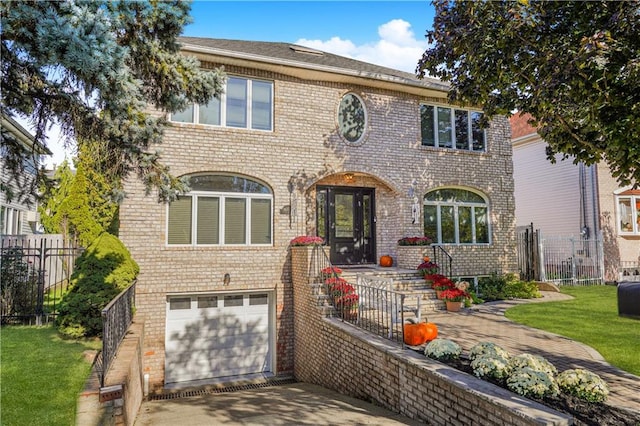 view of front of home featuring a garage and a front lawn