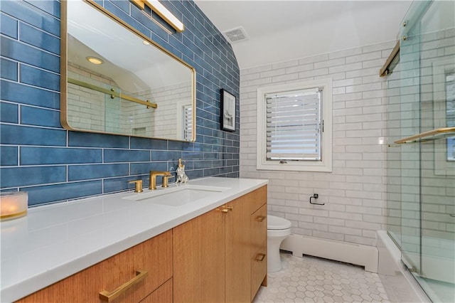 full bathroom featuring tile patterned floors, tile walls, combined bath / shower with glass door, vanity, and backsplash