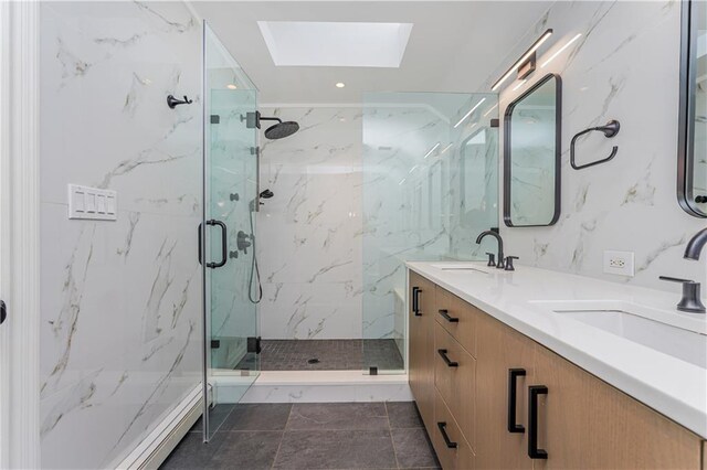 bathroom with vanity, an enclosed shower, and a skylight