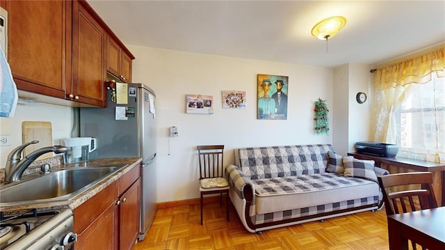 kitchen featuring sink, range, and light parquet floors