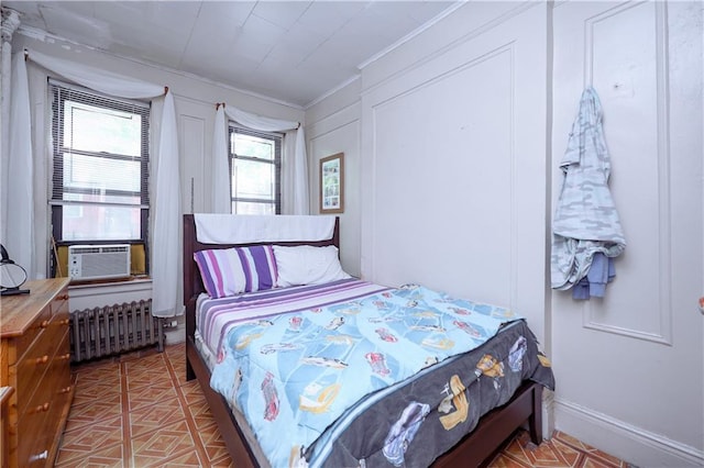 bedroom featuring cooling unit, radiator heating unit, and crown molding