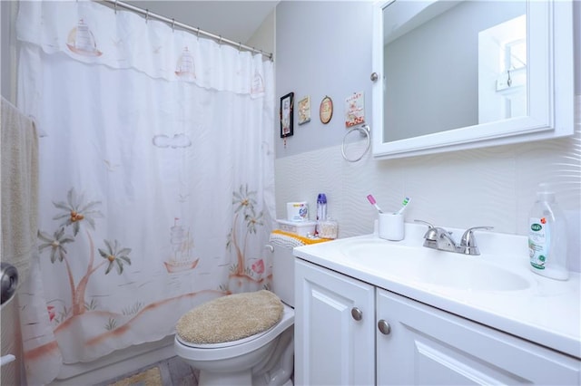 bathroom with vanity, tasteful backsplash, and toilet