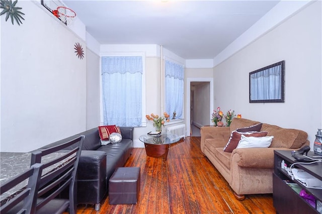 living room featuring radiator heating unit and dark wood-type flooring