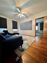 living room featuring hardwood / wood-style flooring and ceiling fan