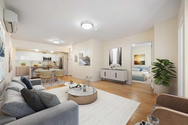 living room with light hardwood / wood-style flooring and a wall mounted AC