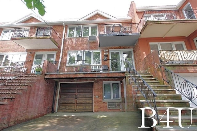 exterior space with a garage and a balcony