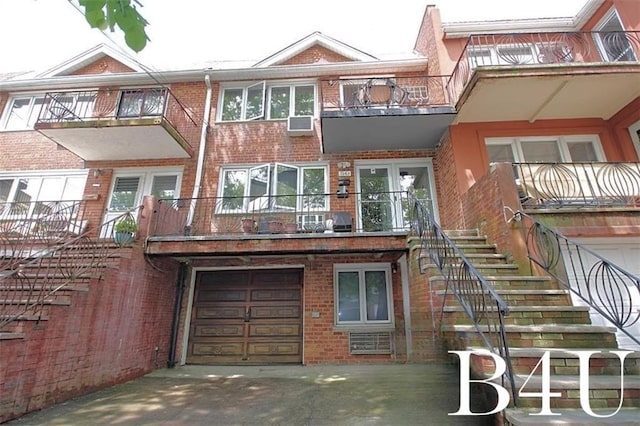 7263 Bergen Ct, Brooklyn, NY 11234 - view of front of house with brick siding, a garage, driveway, and a balcony