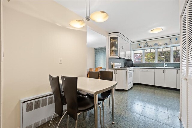 dining area with radiator and sink