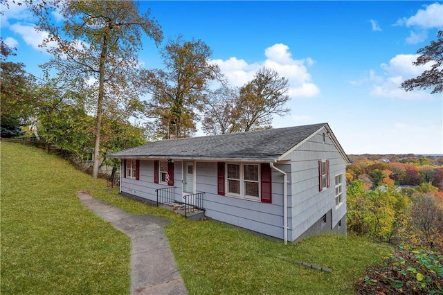 bungalow-style home featuring a front lawn