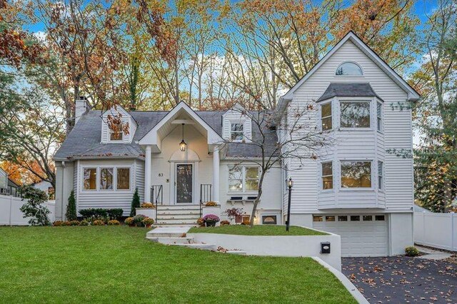 view of front facade with a front yard and a garage