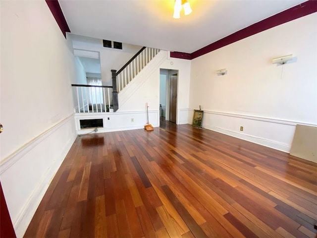 unfurnished living room with dark hardwood / wood-style floors