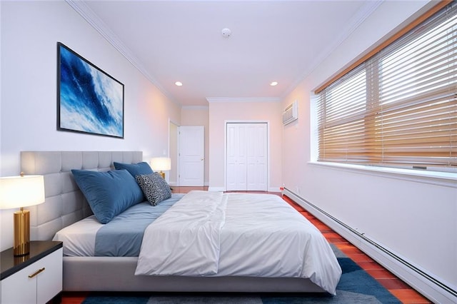 bedroom with dark wood-type flooring, crown molding, baseboard heating, a closet, and a wall unit AC