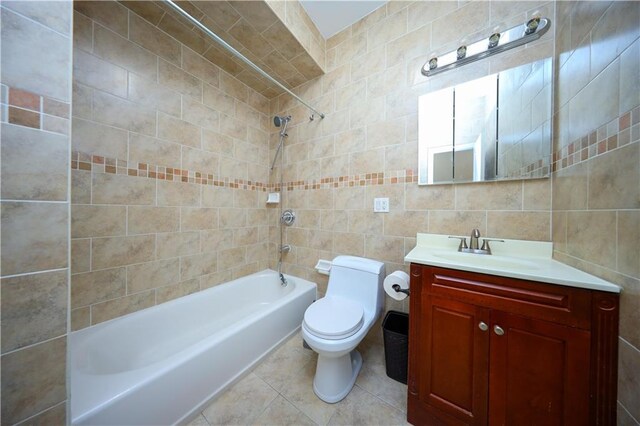 full bathroom featuring tile walls, vanity, shower / bathtub combination, and toilet