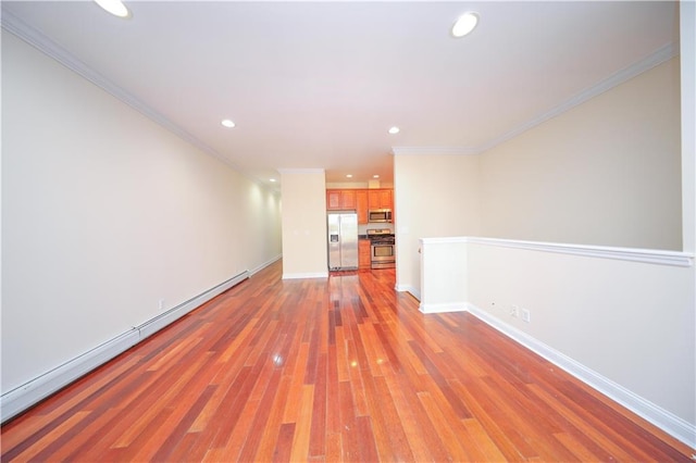 empty room featuring ornamental molding, recessed lighting, light wood finished floors, a baseboard radiator, and baseboards