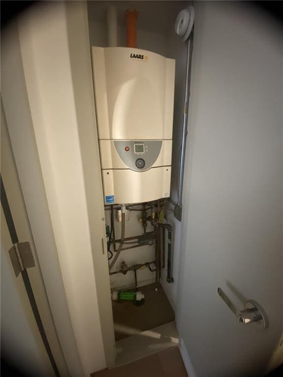 utility room featuring water heater