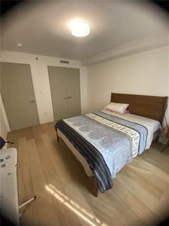 234 E 70th St Unit 4, New York, NY 10021 - bedroom with wood finished floors and a closet