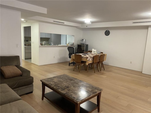 living room with light hardwood / wood-style flooring