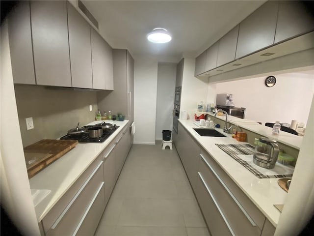 234 E 70th St Unit 4, New York, NY 10021 - kitchen featuring a sink, gray cabinets, stovetop, and modern cabinets
