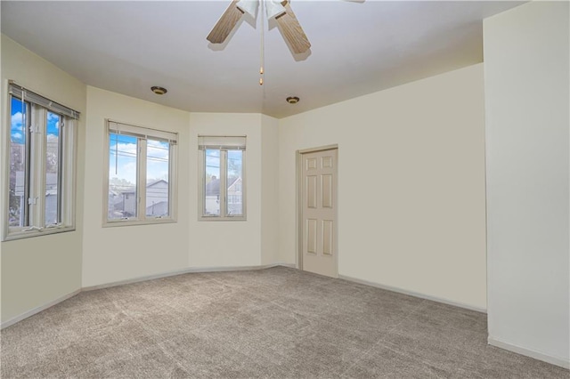 carpeted spare room with ceiling fan