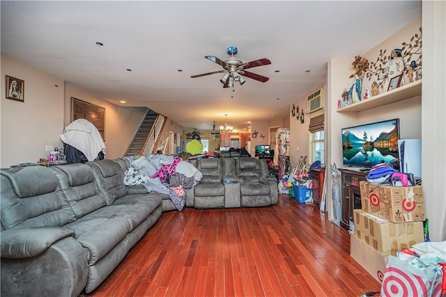 living room featuring hardwood / wood-style floors and ceiling fan with notable chandelier