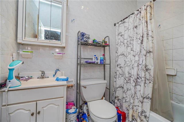 full bathroom with vanity, toilet, tile walls, and shower / bathtub combination with curtain