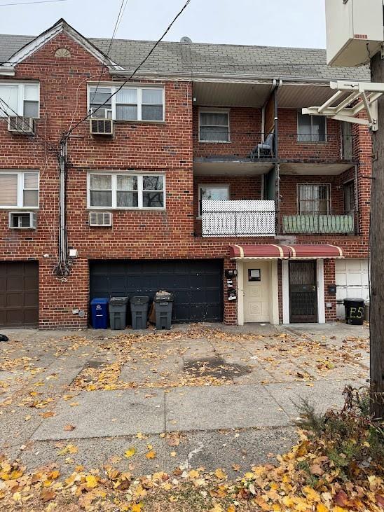 2009 E 55th St, Brooklyn, NY 11234 - view of building exterior featuring an attached garage