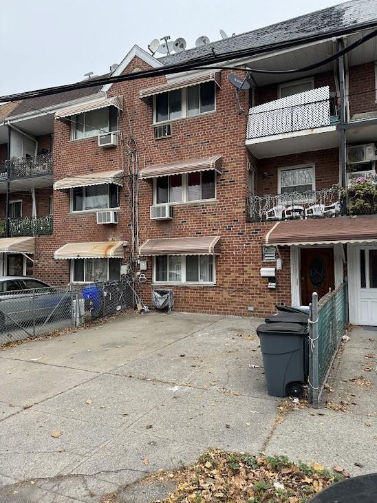 2069 E 55th St, Brooklyn, NY 11234 - view of building exterior featuring cooling unit and fence