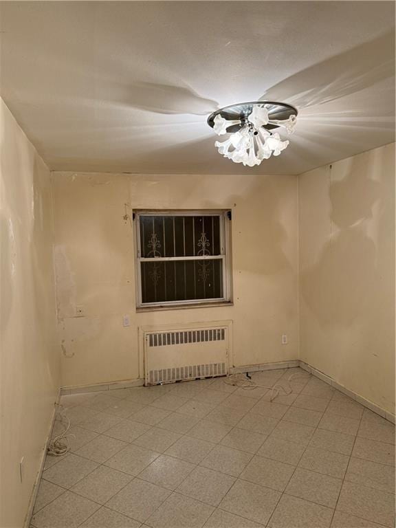 empty room featuring radiator heating unit