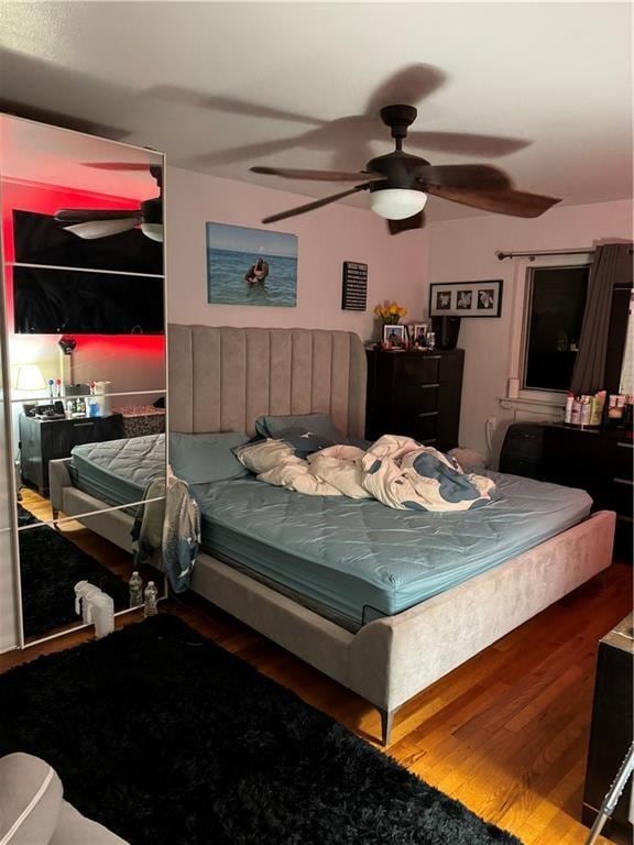 bedroom with hardwood / wood-style floors and ceiling fan