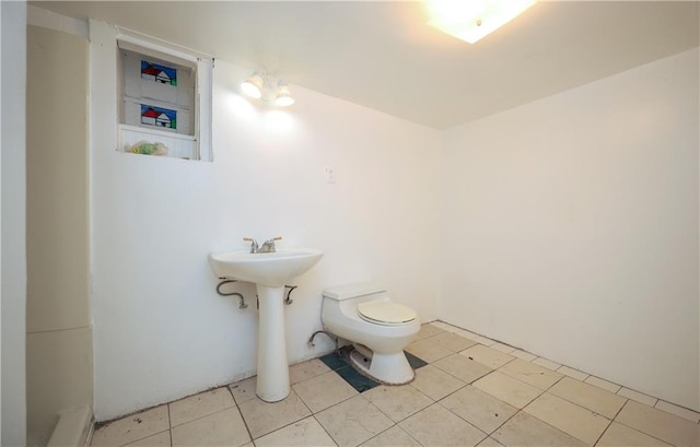 bathroom featuring tile patterned flooring and toilet