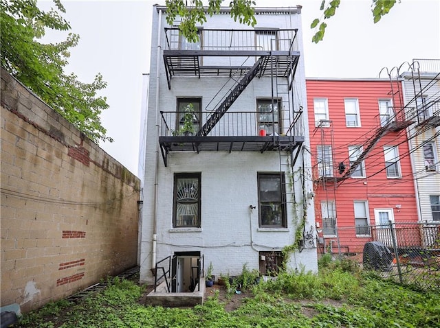 rear view of property with a balcony