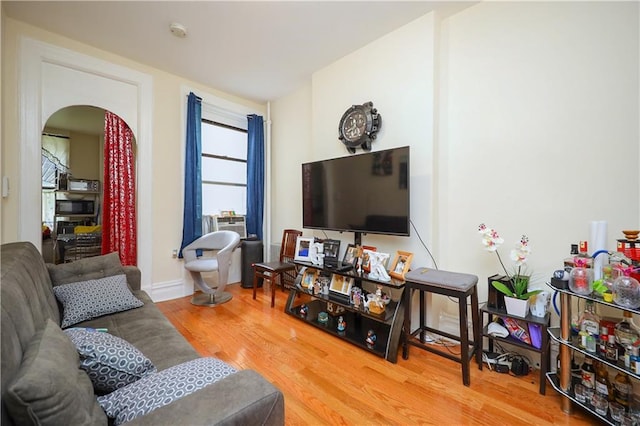 living room with cooling unit and wood-type flooring