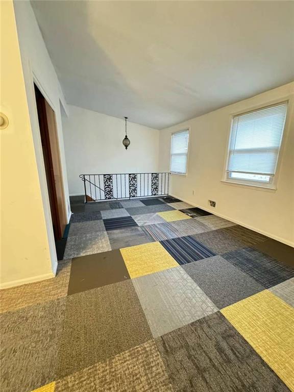 interior space featuring carpet floors and baseboards