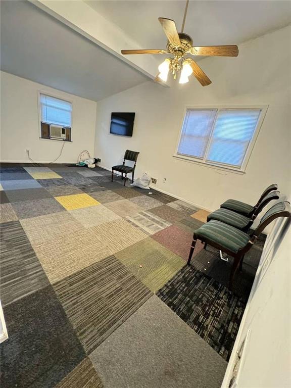 sitting room featuring carpet, cooling unit, ceiling fan, and lofted ceiling