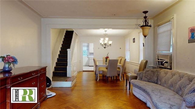 dining area featuring parquet flooring and a notable chandelier