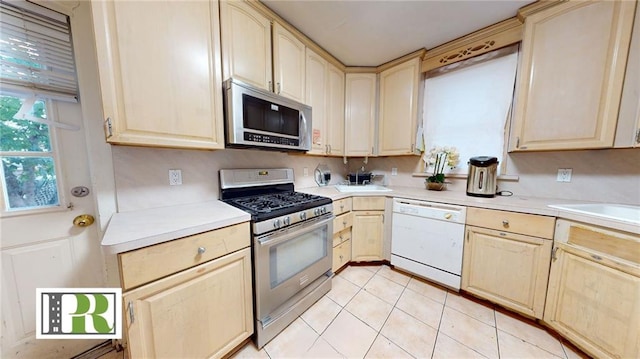 kitchen with light countertops, appliances with stainless steel finishes, and light brown cabinets