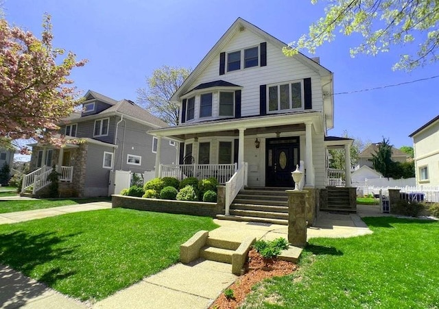 view of front of house featuring a front yard and covered porch