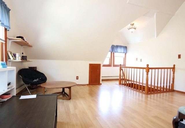 interior space with light hardwood / wood-style floors and vaulted ceiling