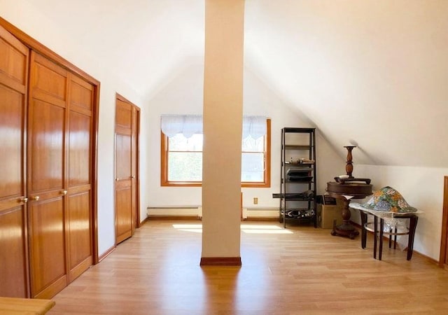 bonus room featuring vaulted ceiling and light hardwood / wood-style flooring