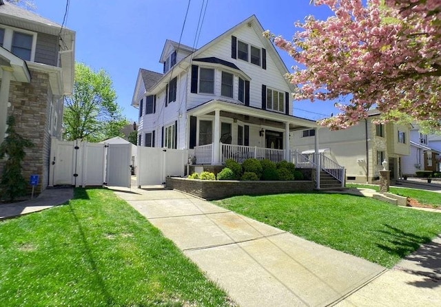 view of front facade with a front yard and a porch